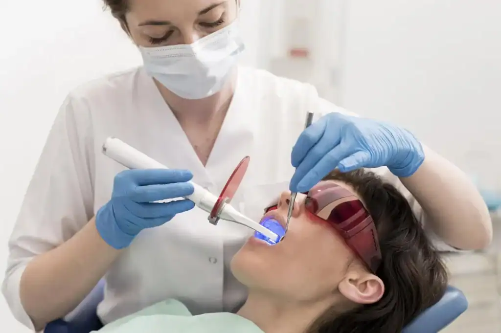Female patient undergoing advanced zoom Laser Teeth Whitening session with dental specialist Watford